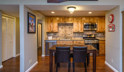 Dining room and kitchen view of hardwood floor and real wood cabinets on lake forest road in tahoe