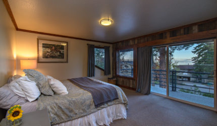 Master bedroom with small balcony and view of neighborhood