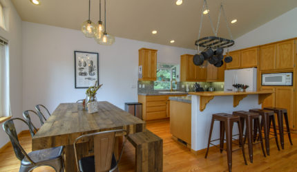 Kitchen with oak cabinets and flooring and large dining table